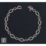 A 14ct white gold diamond bracelet comprising oval diamond set and plain panels, weight 8g, length