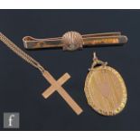 A 9ct hallmarked oval locket, a 9ct cross and chain and a 9ct bar brooch, total weight 16g,