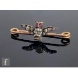 A 19th Century 9ct bar brooch decorated with the study of a diamond set owl with outstretched