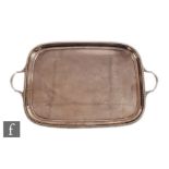 A hallmarked silver cushioned rectangular twin handled tray of plain form with gadroon detail to