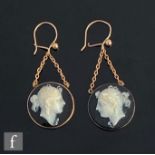 A pair of 9ct mounted hard stone cameo drop earrings, circular black hard stone with the white