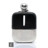 A hallmarked silver, clear glass and leather hip flask of typical form, terminating in cork lined