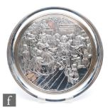 A hallmarked silver Christman plate embossed with a Dickens' scene within plain raised borders,