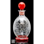 A 1960s Czechoslovakian glass liqueur decanter, of footed ovoid form, the body decorated with