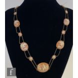 A 9ct cameo necklet comprising fourteen oval cameo panels each depicting a classical scene or animal