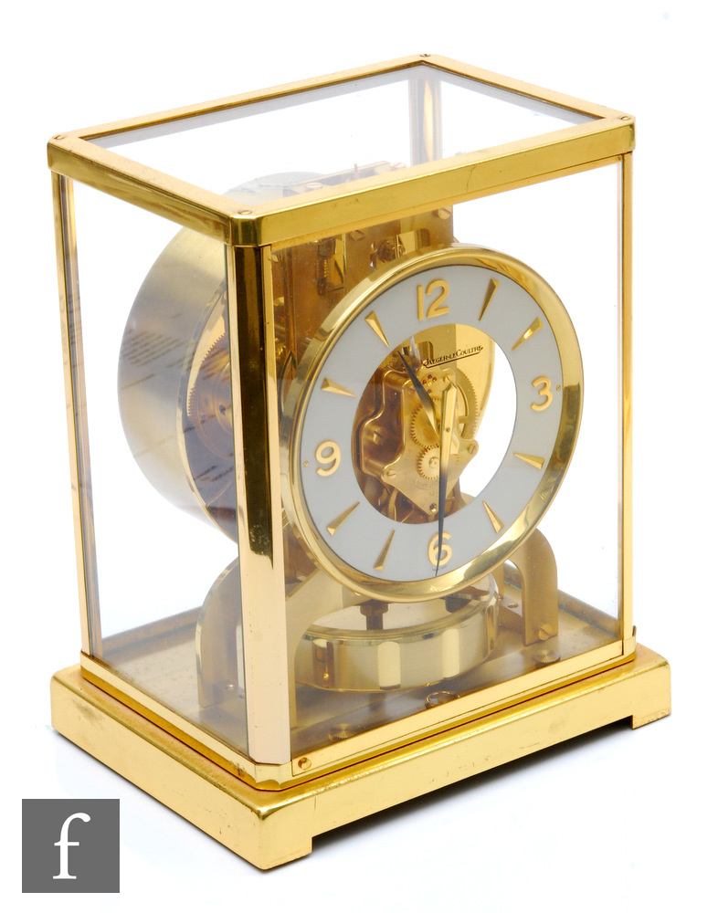 A Jaeger-Lecoultre Atmos clock, circular white dial in brass glazed case, on plinth base, height