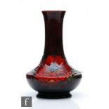 A Moorcroft vase of angular globe and shaft form decorated in the Flambe Anemone pattern,