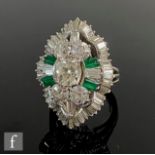 An 18ct white gold emerald and diamond cluster ring, central old cut stone, weight approximately 1.