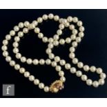 A single row of uniform cultured pearls each approximately 7mm in diameter, terminating in an 18ct
