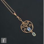 An early 20th Century 9ct open work two stone aquamarine pendant of pierced circular form, length