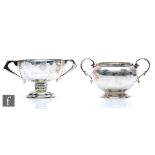 A hallmarked silver twin handed sugar basin with a similar small trophy cup, total weight 10.5oz,