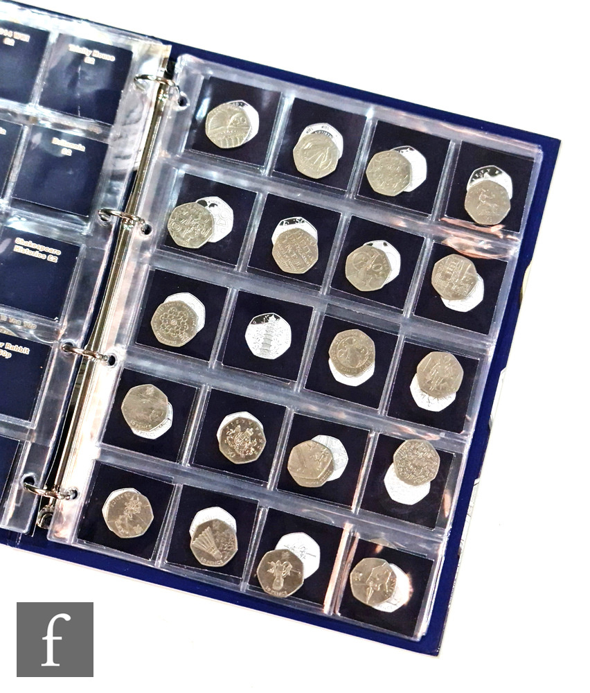 An incomplete Elizabeth II Change Checker album containing two pound coin variants and fifty pences.