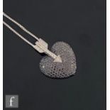 A modern 18ct white gold black and white diamond set pendant modelled as a black heart below a white