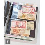 An extensive album of world banknotes to include an American 1857 merchant planters bank for the