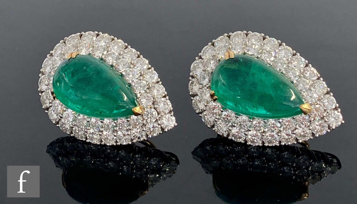 A pair of 18ct white and yellow gold emerald and diamond cluster stud earrings, central claw set