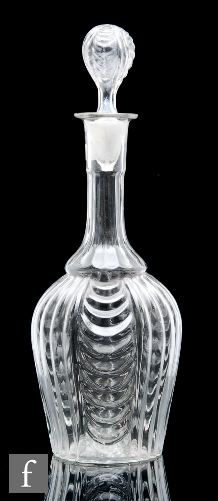 A late 19th Century French three part moulded decanter, of baluster form, the body moulded with