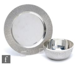 A hallmarked silver small bowl and stand, each with bark effect finish to borders, total weigh