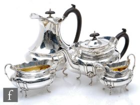 A hallmarked silver four piece, boat shaped tea set each raised on four scroll feet with stylised