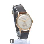 A gentleman's 9ct hallmarked J.W. Benson manual wristwatch, gilt batons to a circular silvered dial,
