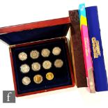 An Elizabeth II Royal Mint London 2012 sports collection folder of fifty pences, a Change Checker