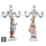 A pair of late 19th to early 20th Century Dresden candelabra with a lady and gentleman stood