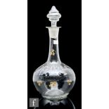 A late 19th or early 20th Century Austrian glass decanter, of globe and shaft form, enamel decorated