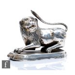 A 19th Century silver study of a crouching lion to a canted rectangular base, weight 11.5oz,