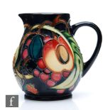 A small Moorcroft Pottery jug decorated in the Queen's Choice pattern designed by Emma Bossons,