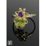 A 9ct hallmarked amethyst, peridot and seed pearl ring modelled as a fly to a plain shank, weight