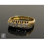 An 18ct hallmarked diamond five stone, boat shaped ring, claw set old cut stones to plain shoulders,