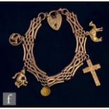 An early 20th Century 9ct four bar gate bracelet with various charms attached, weight 14g,