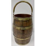 A brass bound elm barrel shaped Coal Bucket, with metal liner and brass swing handles, 16" (