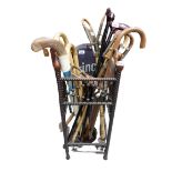 A collection of various Walking Sticks, Canes, Sporting Sticks and a Tennis Racket, all in an ornate