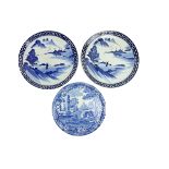 A pair of Japanese blue and white Saucer Dishes, each decorated with a river landscape, 13" (33cms);