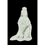 An early blanc-de-chine Chinese porcelain Figure, Quan Yin, she kneeling on one knee holding a