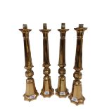 A set of 4 heavy copper Altar Candlesticks, each with a knopped octagonal fluted stem and flared