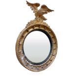 A Regency period gilt convex Wall Mirror, with carved eagle crest on a ball moulded frame, 31"h x