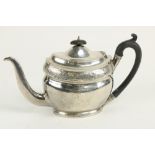 A large boat shaped oval English silver Teapot, with bright cut decoration and armorial crests,