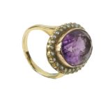 An good large rare purple tourmaline cut oval Stone, set with gold mount surround and 26 pearls,