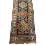 A fine quality antique Carpet / woollen Runner, the central dark blue ground panel with eight