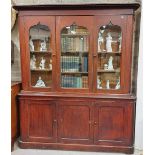 A Victorian stained pine Bookcase, the moulded pediment over three Middle Eastern style arched and