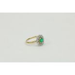 An attractive 18ct gold Ring, with ten diamonds surrounding central green stone (possibly