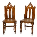 A pair of oak Gothic Revival Side Chairs, in the manner of Pugin, each back with pointed and pierced