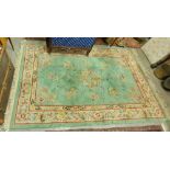 An attractive lime ground heavy woollen Chinese Carpet, with floral centre medallions and corners