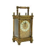 A 19th Century ormolu cased Carriage Clock, with filigree design, enamel face, reeded pillars and