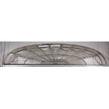 A large glazed metal demi-lune shaped Overdoor Fan Light, partially glazed, 214cms x 51cms (84" x