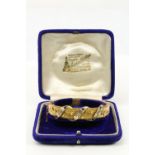 An attractive Edwardian 9ct gold Ladies rigid Bracelet, the interwoven floral design inset with