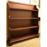 A pair of Georgian style stained Waterfall Bookcases, with shaped sides on plinth bases with bracket