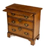 A fine quality walnut Chest, 18th Century and later, the segmented top with herring bone inlay and