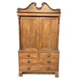 A fine Regency period mahogany Linen Cupboard on Chest, with bead moulded swan neck pediment above